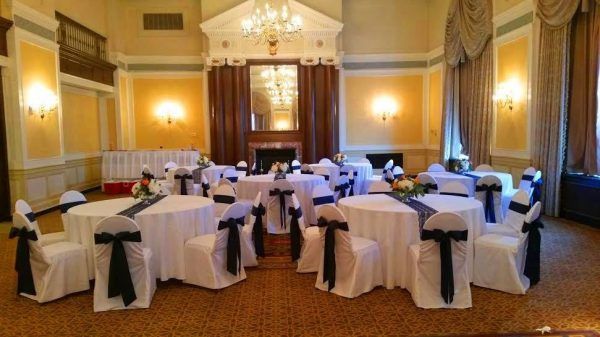 Our colonial ballroom has a few round tables with white tablecloths and dark blue bows and runners.