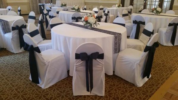 Our colonial ballroom has a few round tables with white tablecloths and dark blue bows and runners.