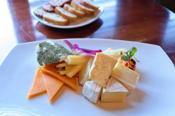 A small plate with a variety of cheeses.