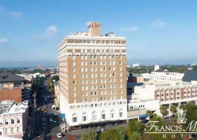 An exterior drone shot of the hotel shows the exterior of the hotel and the surrounding area.