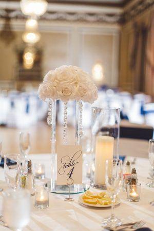 A white floral centerpiece with a table number labeled Table 4.